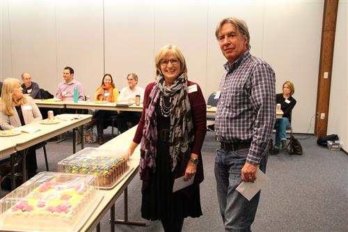Pat Adams and Charles LaRue stand next to their celebratory cakes. 
