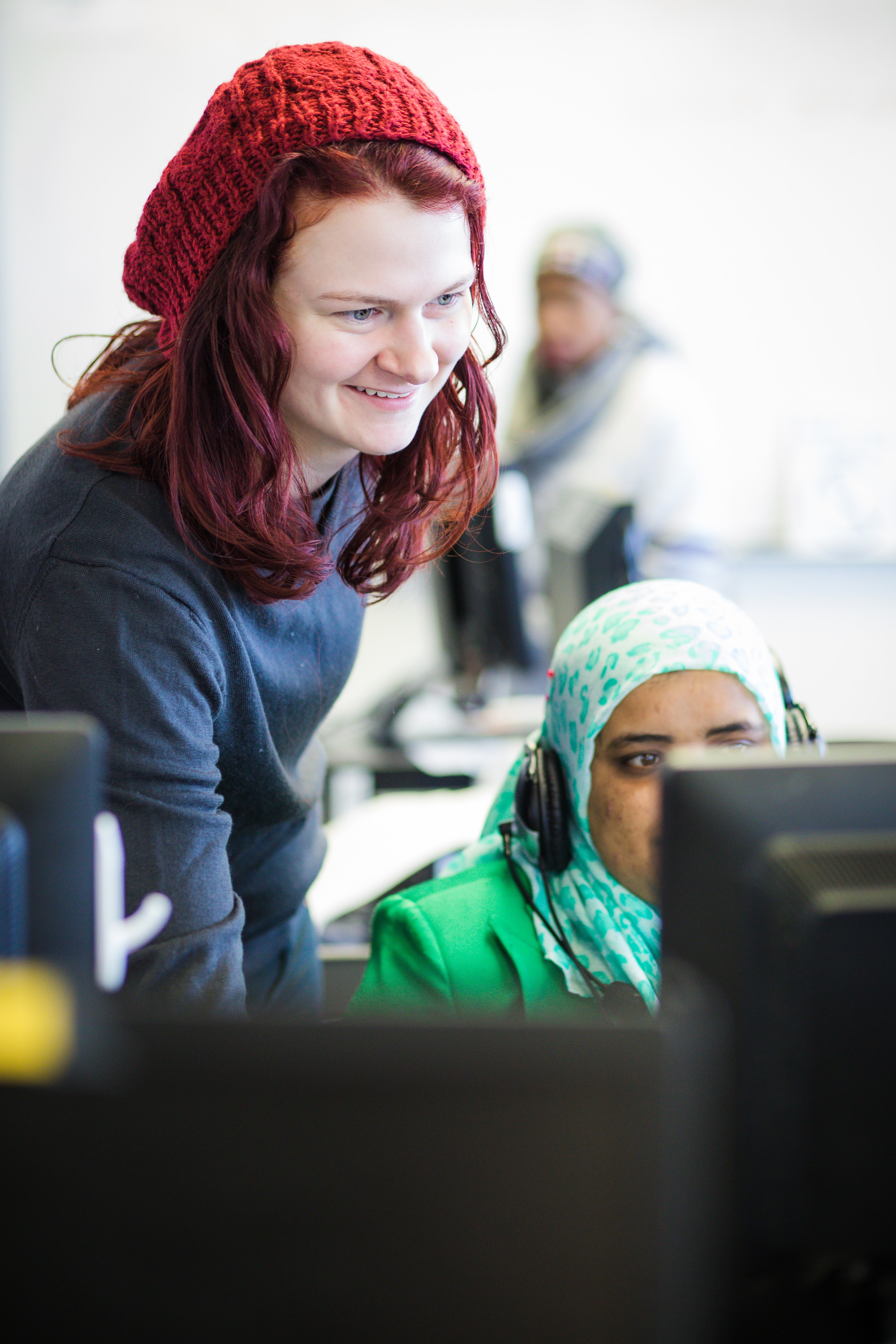 CTEP volunteer assisting student on computer 